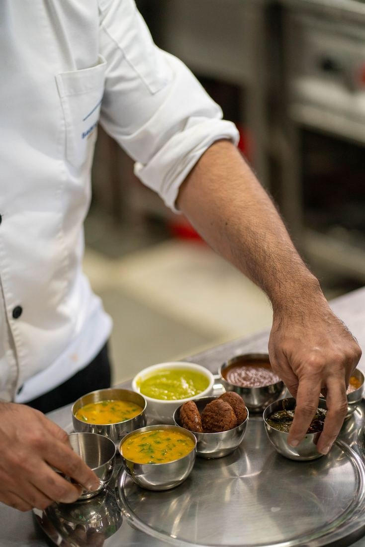 Chef serving a thali